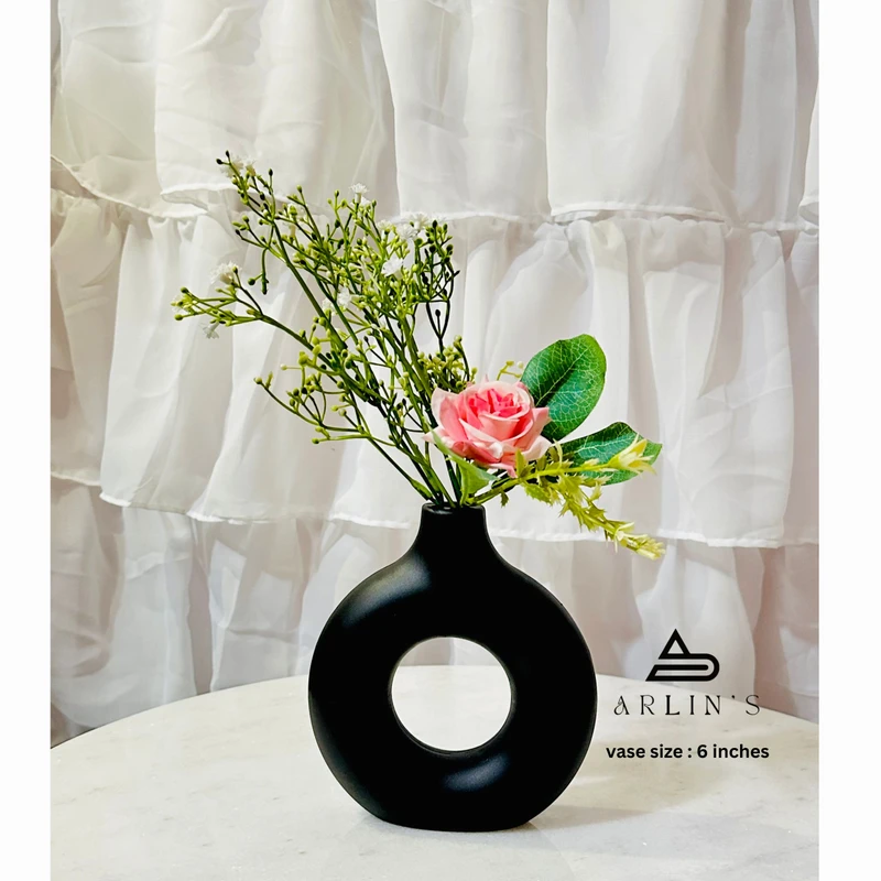 black plastic donut vase with flower